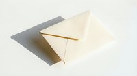 Cream paper envelope on white background with soft shadow, conveying elegance and simplicity for mail, invitation, and correspondence concepts.