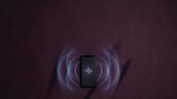 Smartphone with glowing purple energy waves and spiritual symbol on dark textured background, representing technology, mysticism, and digital connectivity for app development and tech marketing.
