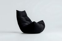 Modern black bean bag chair with ergonomic curved shape on white background, isolated contemporary furniture piece for minimalist interior design and comfort.