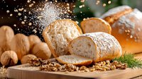 Fresh crusty bread loaf sliced on wooden cutting board with falling flour dust, walnuts and herbs in warm lighting with bokeh effect background.