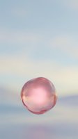 Translucent pink sphere floating against soft pastel sky with gradient clouds, ideal for abstract backgrounds, wellness concepts, and modern design projects.