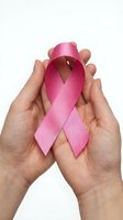 Hands gently holding pink awareness ribbon symbol for breast cancer support and healthcare advocacy on white background.