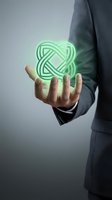 Businessman in dark suit holding glowing green neon geometric knot symbol in palm, representing innovation, technology, and connectivity for corporate branding and business solutions.