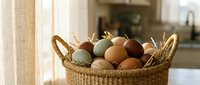 Fresh farm eggs in wicker basket on kitchen counter with natural lighting for organic food cooking and healthy breakfast preparation.