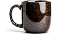 Handcrafted ceramic coffee mug with speckled brown glaze and glossy finish, featuring minimalist design for modern kitchen decor.