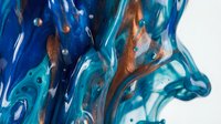 Abstract fluid art with swirling blue and copper metallic paint creating dynamic waves and bubbles on white background for modern interior design.