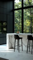 Modern luxury kitchen interior with marble countertop, black bar stools and floor-to-ceiling windows overlooking green forest. Natural sunlight creates peaceful atmosphere.