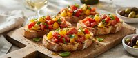 Toasted bread slices topped with diced tomatoes, peppers, and fresh herbs on wooden board, served with wine and olives for appetizers or bruschetta recipes.