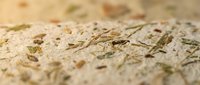 Handmade paper texture with natural fibers and organic materials creating rustic artisan surface for craft projects and eco-friendly design applications.