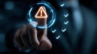 Businessman touching digital warning sign with checklist, concept of risk management and cybersecurity in corporate environment.