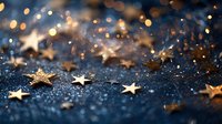 Golden star confetti scattered on dark blue glittery surface with bokeh lights creating festive holiday atmosphere for celebration backgrounds.