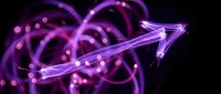 Glowing purple neon arrow with light trails and bokeh effects on black background for digital design and technology concepts.