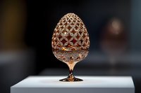 Ornate metallic rose gold egg with intricate filigree pattern on pedestal stand against dark background, luxury decorative art piece for elegant home decor and design projects.