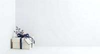 Stacked cream gift boxes with navy ribbon bow and white gypsophila flowers on white background, isolated for holiday design projects.