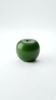Fresh green apple with glossy skin isolated on white background, ready for health and nutrition design projects.