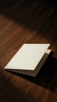 Blank white business cards on dark wooden surface with dramatic lighting and shadows for corporate branding and identity design mockup.