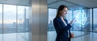 Professional businesswoman using holographic technology interface in modern corporate office with city skyline view during daytime.