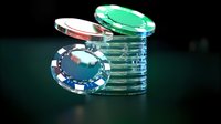 Stack of colorful poker chips on dark background with dramatic lighting, showing red, green and blue casino gaming pieces with selective focus and blur effects.