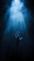 Silhouette of raised hand reaching toward mysterious blue light rays piercing through dark smoke, creating dramatic spiritual atmosphere for faith concepts.