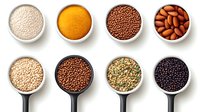Collection of various grains, seeds and nuts in white ceramic bowls and measuring spoons arranged in neat rows on white background, isolated overhead view.