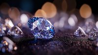 Sparkling blue diamond on glittering dark surface with soft bokeh lights in background creates luxurious jewelry atmosphere. Perfect for luxury advertising.