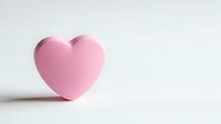 Pink heart shape on clean white background with soft shadow, minimalist love symbol for romantic designs and Valentine's Day projects.