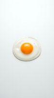 Fresh fried egg with bright orange yolk isolated on white background for breakfast menu design and culinary projects.