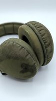 Olive green fabric over-ear headphones with padded ear cups and adjustable headband, suitable for music, gaming, and audio equipment marketing.