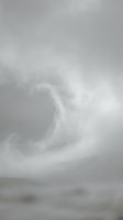 Dramatic swirling storm clouds in monochrome sky creating moody atmospheric weather patterns over blurred landscape horizon for meteorology concepts.
