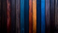 Colorful wooden planks in dark blue, orange and burgundy tones create dramatic vertical stripes pattern. Natural wood grain texture visible throughout background.