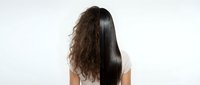 Woman showing hair transformation from curly to straight sleek styling on white background for beauty salon marketing and haircare product advertising.
