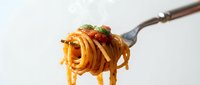 Spaghetti pasta twirled on fork with tomato sauce, basil and herbs isolated on white background ready for culinary design and restaurant menu use.