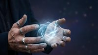 Male hands cupping glowing blue energy orb with light trails in dark mystical atmosphere for spiritual healing and magic concepts.