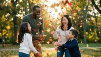 Multiethnic family with two children playing with autumn leaves in park during golden hour sunset, capturing joyful moments of togetherness and seasonal outdoor recreation.