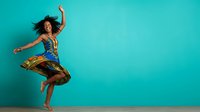 Young woman with curly dark hair and medium brown skin tone, wearing colorful patterned pants and blue top, jumping joyfully against turquoise background for lifestyle and wellness content.