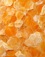 Fresh juicy mandarin or tangerine segments close-up macro shot showing natural citrus fruit texture and pulp membranes in bright orange color.