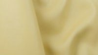 Soft beige fabric with gentle folds and natural texture, suitable for backgrounds, textile design, fashion, and interior styling projects.