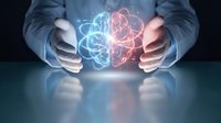 Hands holding glowing brain with blue and red neural connections, representing artificial intelligence, machine learning, and digital innovation for technology concepts.