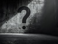 Large question mark shadow cast on grungy concrete wall in dark mysterious room, dramatic lighting creates moody atmosphere for concept designs.