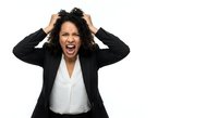 Frustrated mixed race businesswoman screaming with hands in curly hair wearing black suit jacket on white background isolated for design use.