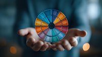 Colorful segmented wheel floating above outstretched hands, symbolizing choice, fortune, or decision-making in business strategy and personal development.