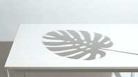 Monstera leaf shadow cast on white surface, creating natural light and shade pattern for interior design and botanical styling projects.