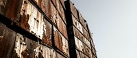 Weathered industrial brick wall with rust stains and peeling paint texture, suitable for urban backgrounds, grunge overlays, and architectural design projects.