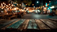 Empty wooden table surface with colorful bokeh lights background for product display and food presentation in restaurant or cafe setting.