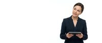 Professional businesswoman in dark suit holding tablet computer on white background for corporate presentations and marketing materials.