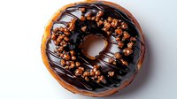Freshly baked chocolate glazed donut topped with dark chocolate drizzle and crunchy caramelized nuts on light background, close up view for bakery menu.