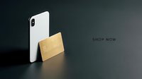 White smartphone and gold credit card on dark background with shop now text, modern digital payment concept for banking and retail.