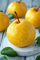 Fresh yellow apples with water droplets on rustic white wooden background. Healthy organic fruit harvest concept for natural nutrition and wellness.