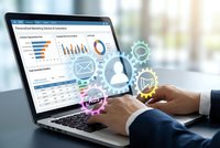 Business professional analyzing data dashboard on laptop with digital marketing icons overlay in modern office environment for corporate analytics.
