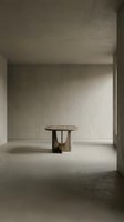 Minimalist wooden table in empty concrete room with natural light, suitable for interior design, architecture, and furniture concepts.